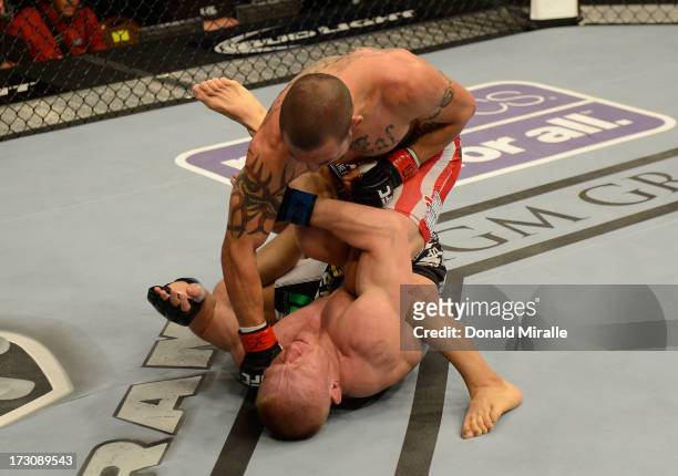 Cub Swanson punches Dennis Siver in their featherweight fight during the UFC 162 event inside the MGM Grand Garden Arena on July 6, 2013 in Las...