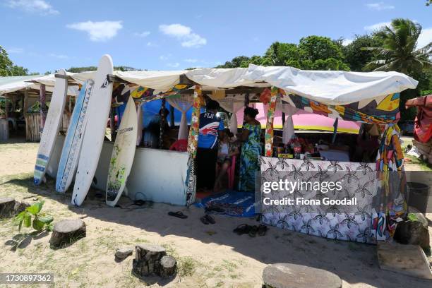 Women from Sanasana village braid a child's hair in their hut at Natadola Beach on Fiji's Coral Coast on October 10, 2023 in Viti Levu, Fiji. Tourism...