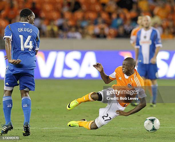 Oscar Boniek Garcia of the Houston Dynamo is tripped up by Amobi Okugo of the Philadelphia Union in the second half at BBVA Compass Stadium on July...