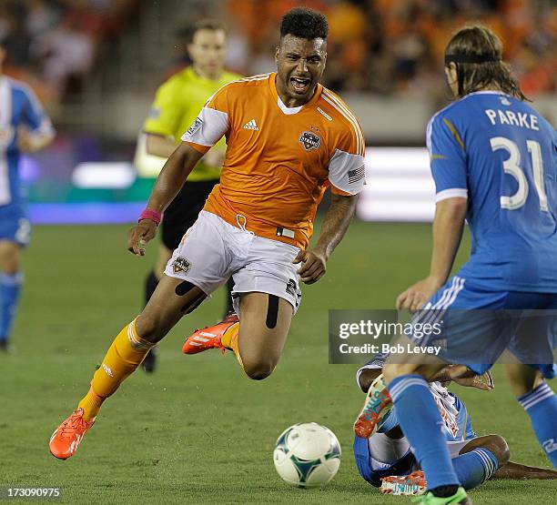 Giles Barnes of the Houston Dynamo is tripped up from behind by Sheanon Williams of the Philadelphia Union in the second half at BBVA Compass Stadium...