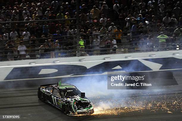 Denny Hamlin, driver of the FedEx Ground Toyota, crashes during the NASCAR Sprint Cup Series Coke Zero 400 at Daytona International Speedway on July...