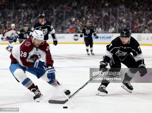 Miles Wood of the Colorado Avalanche attempts to turn with the puck as he is chased by Tobias Bjornfot of the Los Angeles Kings during the third...