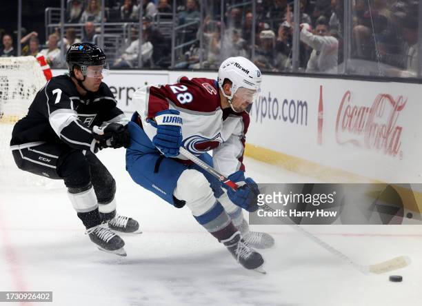 Miles Wood of the Colorado Avalanche turns in the corner with the puck in front of Tobias Bjornfot of the Los Angeles Kings during the third period...