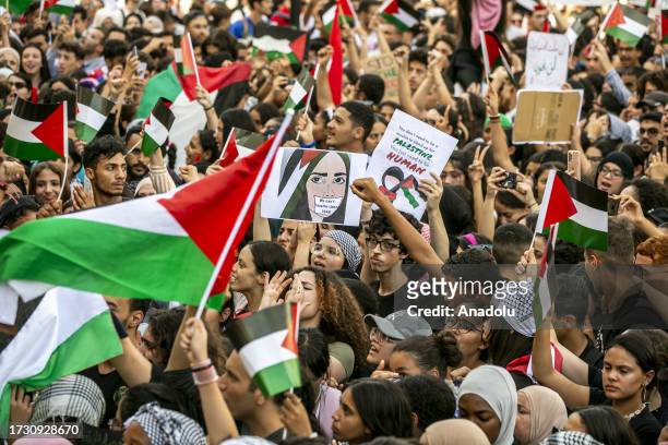 High school and university students carrying the Palestinian and Tunisian flags gather to protest against Israeli airstrikes in Gaza Strip, at Avenue...