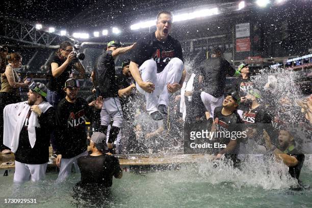 The Arizona Diamondbacks celebrate in the pool after beating the Los Angeles Dodgers 4-2 in Game Three of the Division Series at Chase Field on...
