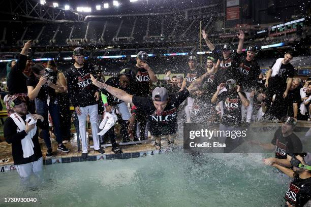 The Arizona Diamondbacks celebrate in the pool after beating the Los Angeles Dodgers 4-2 in Game Three of the Division Series at Chase Field on...