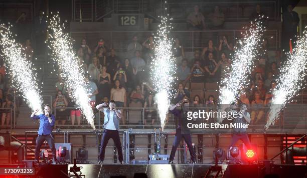 Singers Drew Lachey, Nick Lachey, Justin Jeffre and Jeff Timmons of 98 Degrees perform at the Mandalay Bay Events Center during The Package Tour on...