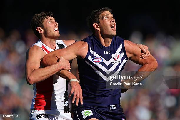 Aaron Sandilands of the Dockers and Tom Hickey of the Saints contest a boundary throw in during the round 15 AFL match between the St Kilda Saints...