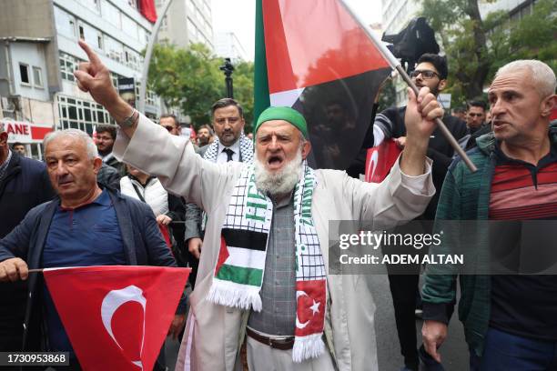 Demonstrator wearing a scalf bearing The Turkish and Palestinian flag chants as they march in support of Palestinians from Kocatape Mosque to Abdi...