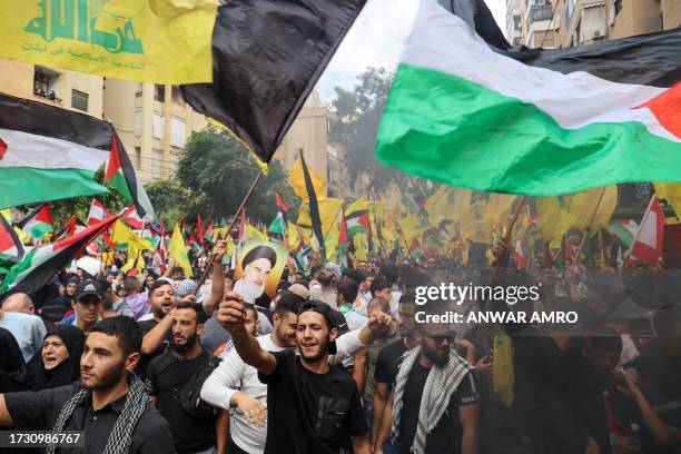 People take part in a demonstration organised by Lebanese Shiite group Hezbollah in the southern suburbs of Beirut on October 18 following a strike...