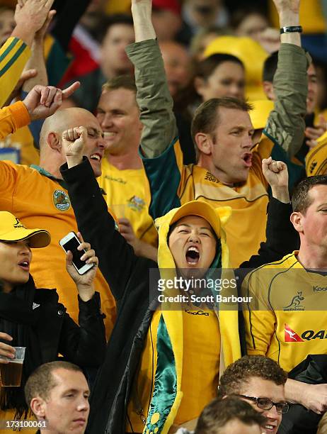 Wallabies supporters celebrate after James O'Connor of the Wallabies scored a try during the International Test match between the Australian...