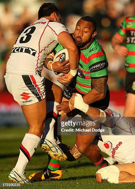 Roy Asotasi of the Rabbitohs gets tackled by Elijah Taylor of the Warriors during the round 17 NRL match between the South Sydney Rabbitohs and the...