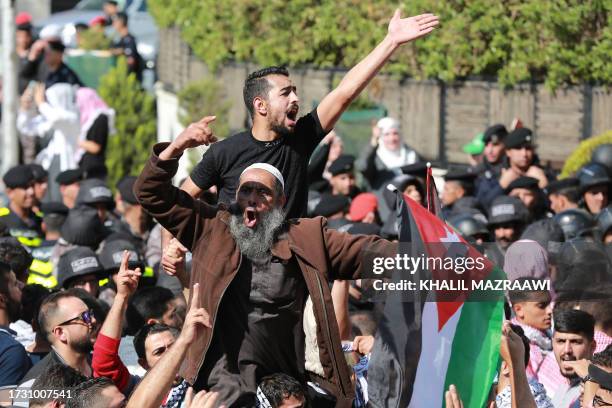 People protest near the Israeli Embassy in Amman on October 18 as they demonstrate against the killing of hundreds of Palestinians following a strike...