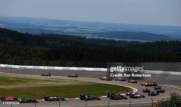 Sebastian Vettel of Germany and Infiniti Red Bull Racing and Mark Webber of Australia and Infiniti Red Bull Racing lead the field at the start of the...