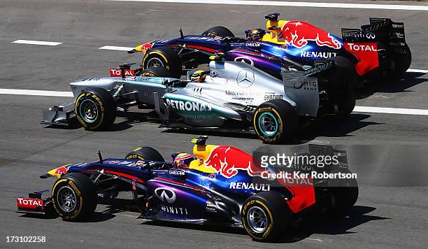 Sebastian Vettel of Germany and Infiniti Red Bull Racing, Lewis Hamilton of Great Britain and Mercedes GP and Mark Webber of Australia and Infiniti...