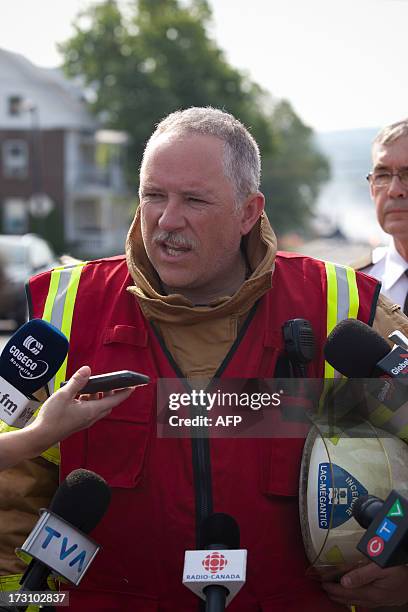 Fire Chief of the Lac-Mégantic fire department, Denis Lauzon briefs reporters July 7, 2013 as his crews continue to work extinguishing fires after a...