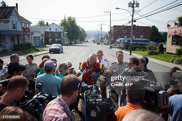 Fire Chief of the Lac-Mégantic fire department, Denis Lauzon briefs reporters July 7, 2013 as his crews continue to work extinguishing fires after a...