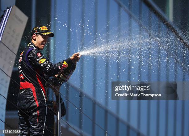 Sebastian Vettel of Germany and Infiniti Red Bull Racing celebrates on the podium after winning the German Grand Prix at the Nuerburgring on July 7,...