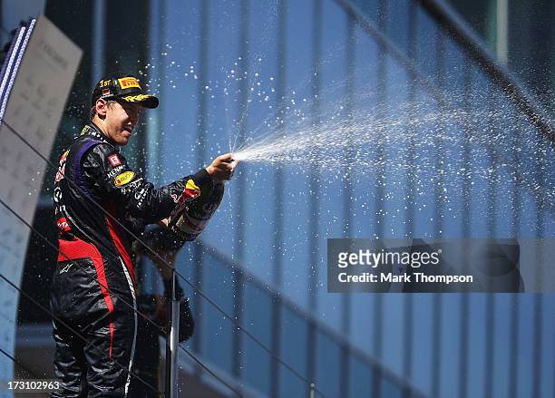 Sebastian Vettel of Germany and Infiniti Red Bull Racing celebrates on the podium after winning the German Grand Prix at the Nuerburgring on July 7,...