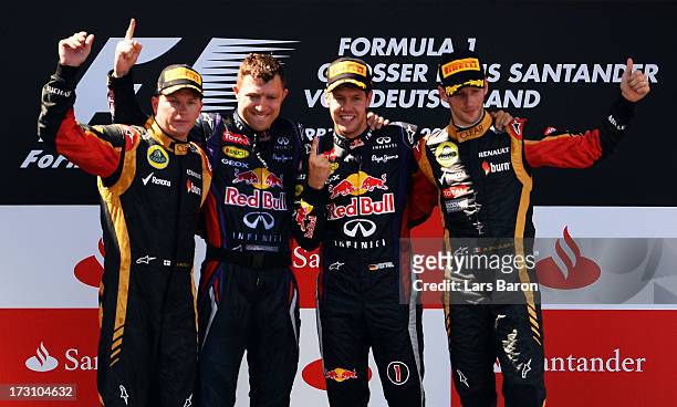 Race winner Sebastian Vettel of Germany and Infiniti Red Bull Racing celebrates on the podium with second placed Kimi Raikkonen of Finland and Lotus,...