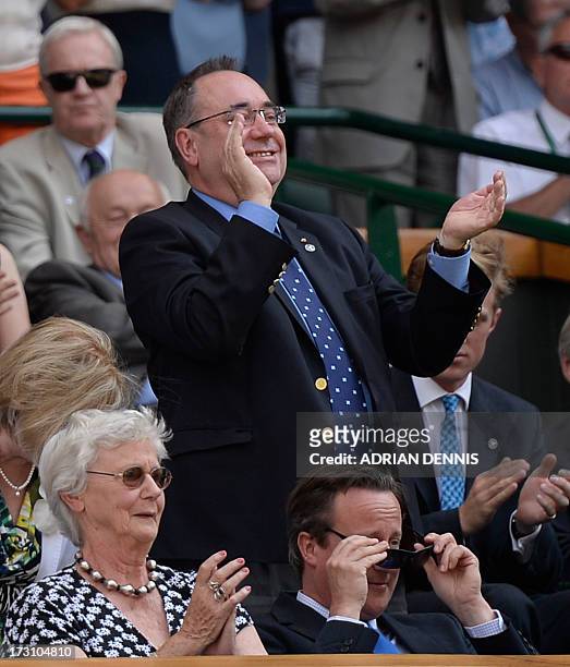 Scotland's First Minister Alex Salmond stands to applaud behind British Prime Minister David Cameron and his mother Mary after Britain's Andy Murray...