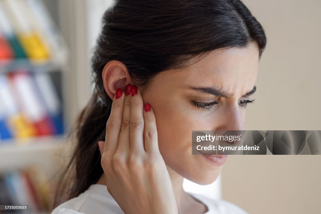 Woman have tinnitus,noise whistling in her ears