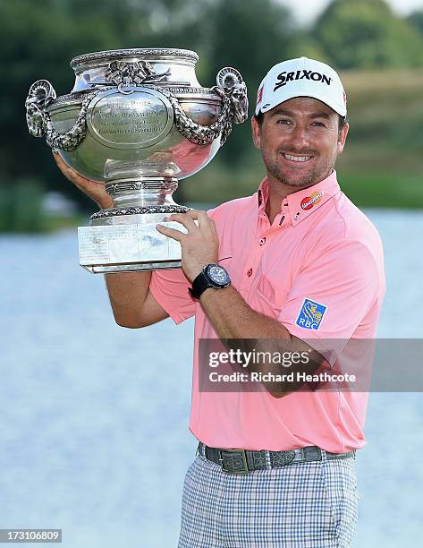 Graeme McDowell of Northern Ireland poses with the trophy after victory in the final round of the Alstom Open de France at Le Golf National on July...