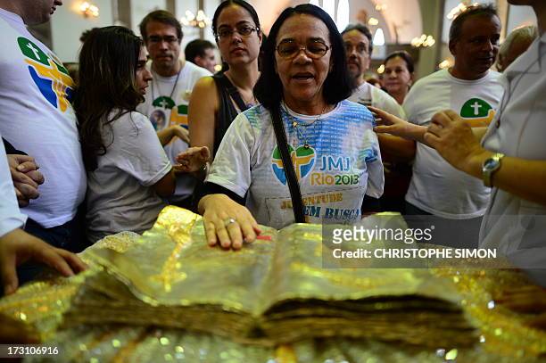 Faithful touches a relic after a mass officiated by Cardinal Stanislaw Rylko to celebrate the arrival in Brazil of the relics of blessed John Paul II...