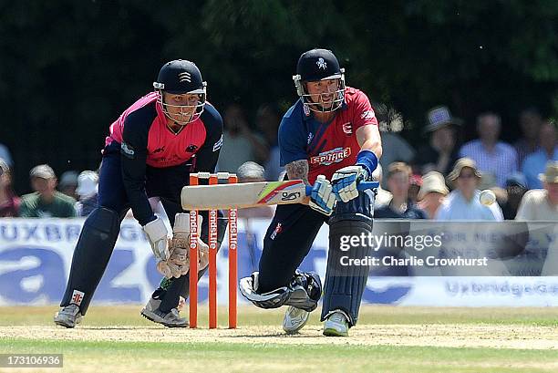 Darren Stevens of Kent lines up a sweep while Adam Rossington of Middlesex looks on during the Friends Life T20 match between Middlesex Panthers and...