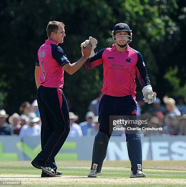 Neil Dexter of Middlesex celebrates a wicket with team mate Adam Rossington during the Friends Life T20 match between Middlesex Panthers and Kent...