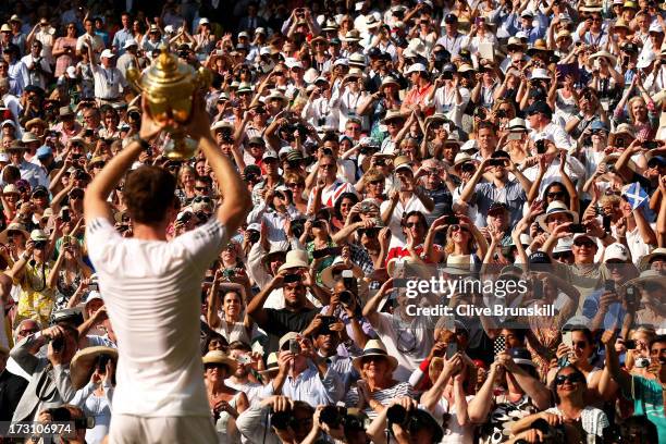 Fans cheer and take photographs as Andy Murray of Great Britain poses with the Gentlemen's Singles Trophy following his victory in the Gentlemen's...