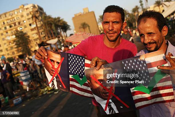 People hold anti President Obama signs at a large rally in Tahrir Square against ousted Egyptian President Mohamed Morsi on July 7, 2013 in Cairo,...