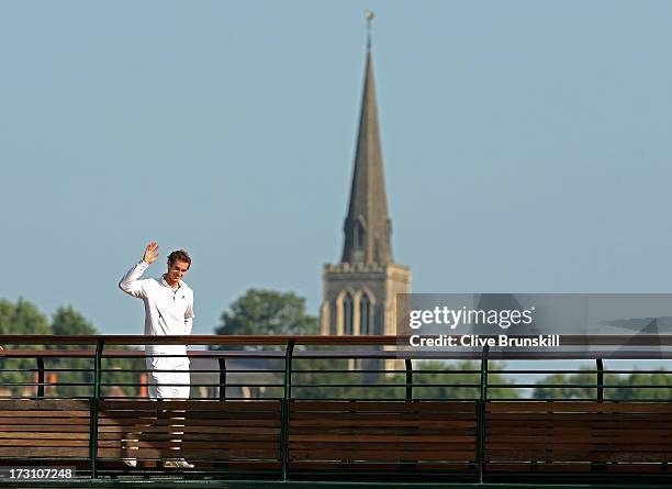 Andy Murray of Great Britain waves to the crowd backdropped by the Wimbledon Village Church following his victory in the Gentlemen's Singles Final...