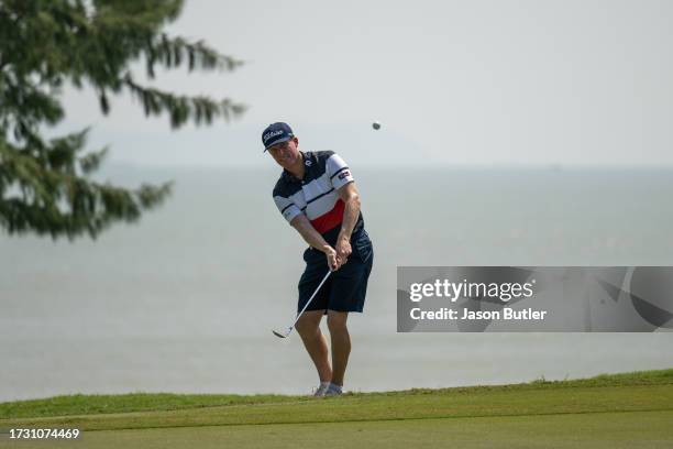 Andrew Dodt of Australia plays onto the green on hole 18 during the first round of the SJM Macao Open at Macau Golf and Country Club on October 12,...