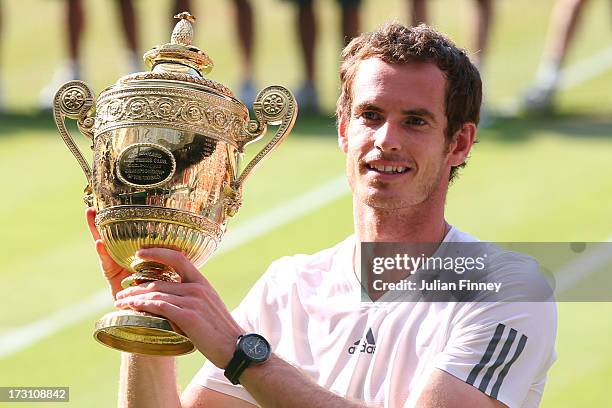Andy Murray of Great Britain poses with the Gentlemen's Singles Trophy following his victory in the Gentlemen's Singles Final match against Novak...