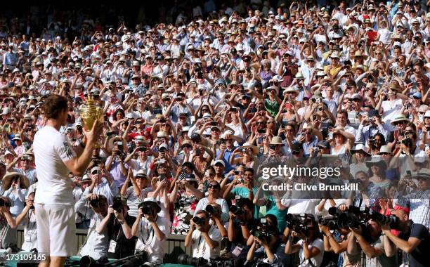 Fans cheer and take photographs as Andy Murray of Great Britain poses with the Gentlemen's Singles Trophy following his victory in the Gentlemen's...