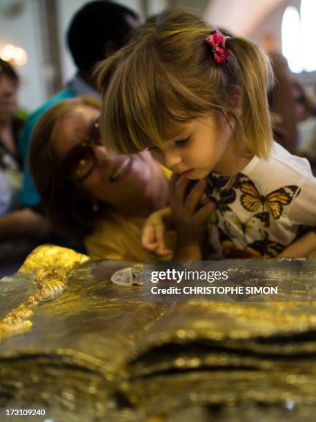 Girl looks at a relic after a mass officiated by Cardinal Stanislaw Rylko to celebrate the arrival in Brazil of the relics of blessed John Paul II at...