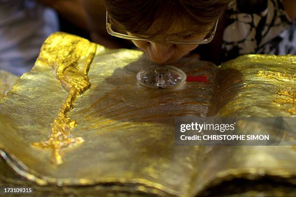 Woman kisses a relic after a mass officiated by Cardinal Stanislaw Rylko to celebrate the arrival in Brazil of the relics of blessed John Paul II at...