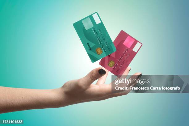 woman's hand throws credit cards in the air - credit card mockup stock pictures, royalty-free photos & images