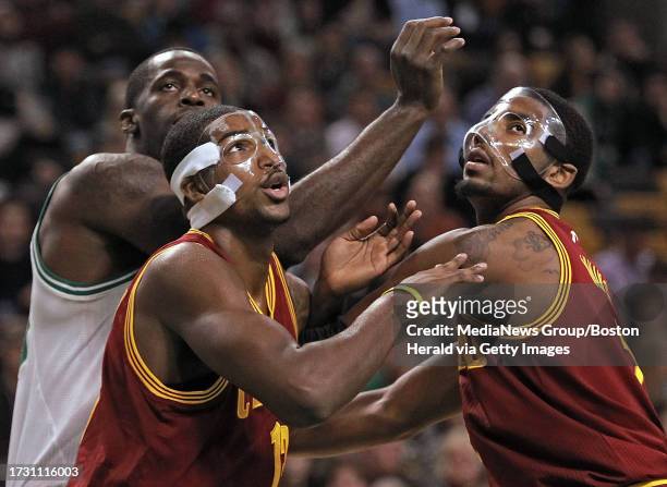 Boston - MA- - Masked men, Cleveland Cavaliers power forward Tristan Thompson and point guard Kyrie Irving rebound a foul shot with Boston Celtics...