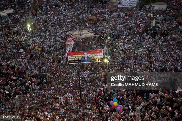 Egyptian supporter of the Muslim Brotherhood rally in support of deposed president Mohamed Morsi outside Cairo's Rabaa al-Adawiya mosque on July 7 as...