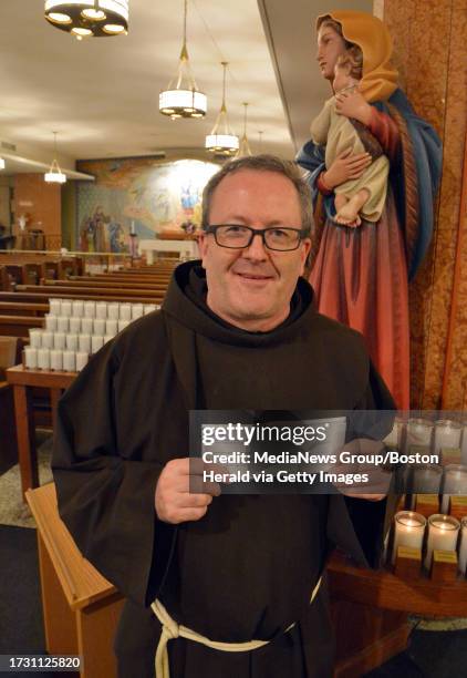 Thomas E. Conway O.F.M. Executive Director of St. Anthony's Shrine holds a check from the Massachusetts Lottery. Staff photo Chris Christo Thomas E....