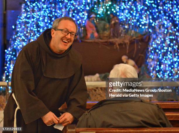 Holding a check from the Massachusetts Lottery, Thomas E. Conway O.F.M. Executive Director of St. Anthony's Shrine has a lot to smile about as he...