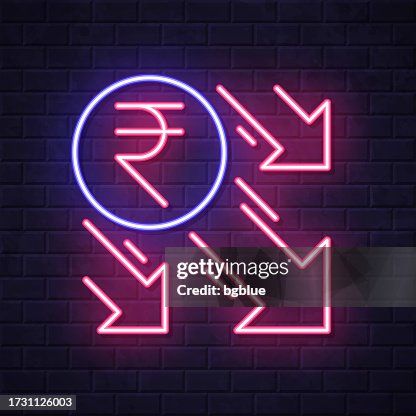 Indian rupee decrease. Glowing neon icon on brick wall background Indian rupee decrease. Glowing neon icon on brick wall background