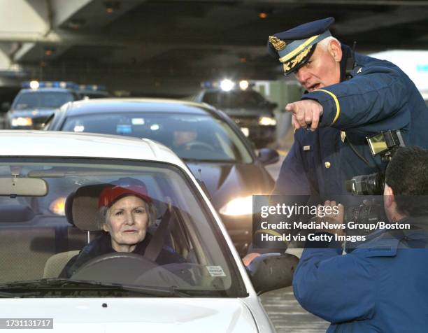 1st car thru central the new 93 South central artery tunnel is stopped on the Zakim Bridge and mobbed by the press. Elaine Cronin of Boston is the...