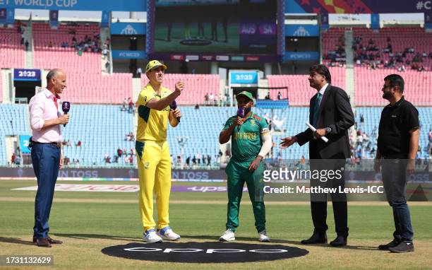Pat Cummins of Australia flips the coin as Temba Bavuma of South Africa looks on ahead of the ICC Men's Cricket World Cup India 2023 between...