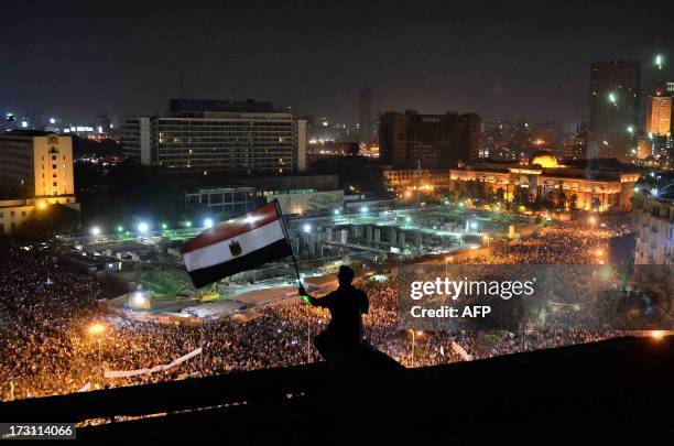 Fireworks light up the sky on July 7, 2013 as hundreds of thousands Egyptians flood Cairo's landmark Tahrir square to demonstrate against ousted...