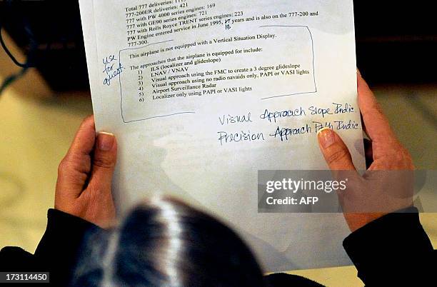 Seen from above, National Transportation Safety Board Chairman Deborah Hersman refers to her notes as she speaks during a news conference at San...