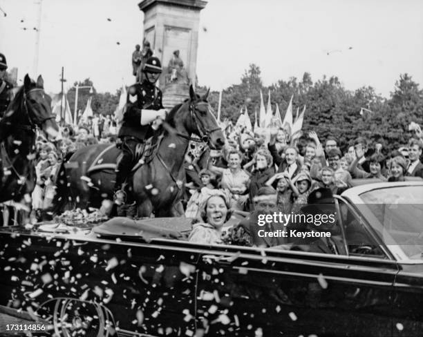 Well-wishers surround the car of Princess Beatrix of the Netherlands and her fiancee Claus van Amsberg , after they announced the date of their...