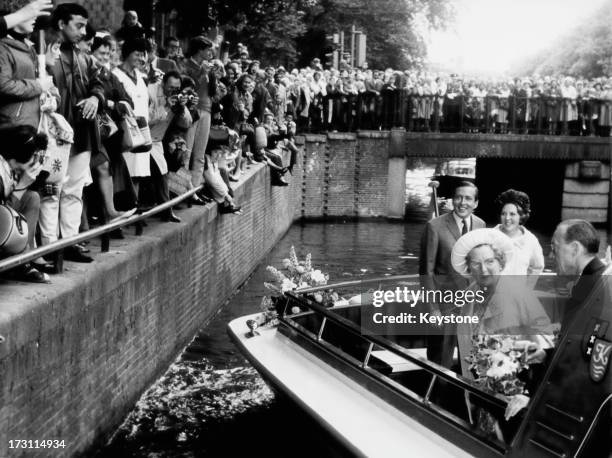 Members of the Dutch royal family on a barge during a visit to Amsterdam, 3rd July 1965. Front: Queen Juliana and Prince Bernhard . Back: Princess...